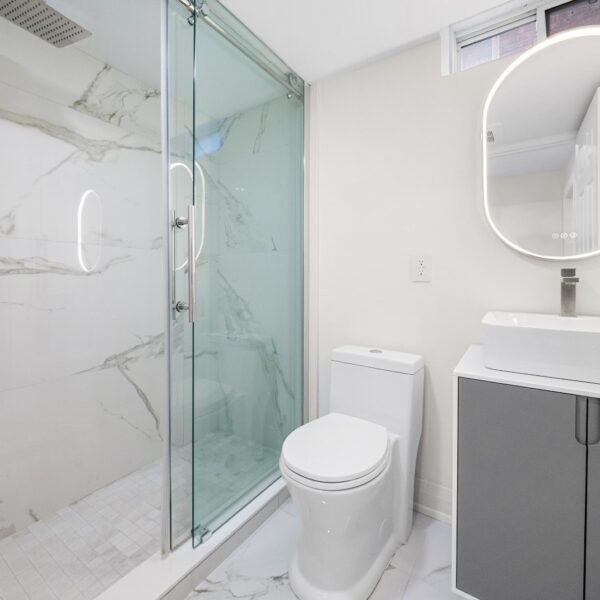 bathroom with white theme renovation by Shahkar renovation compay