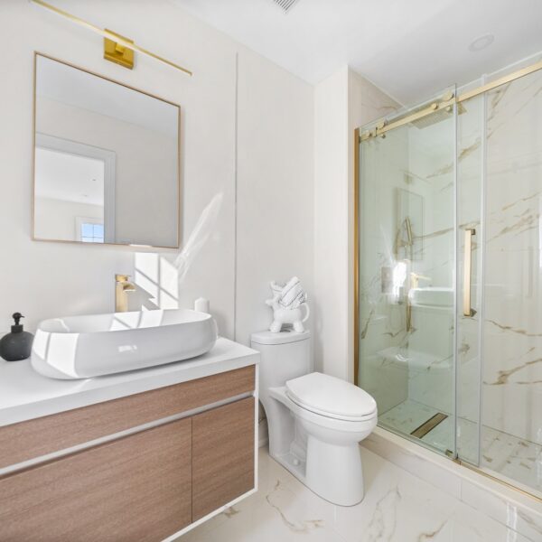 bathroom renovation with white and gold theme